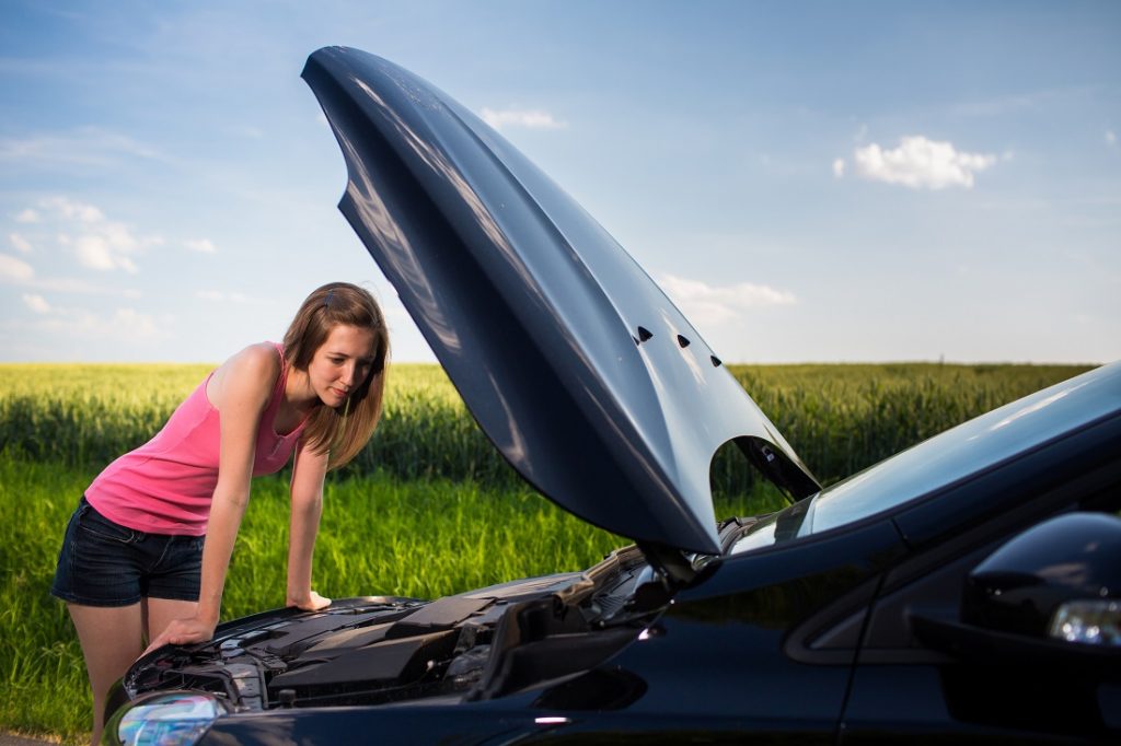 Woman Under Hood Needing Emergency Road Service