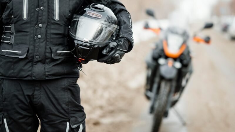 man with his helment and motorcycle